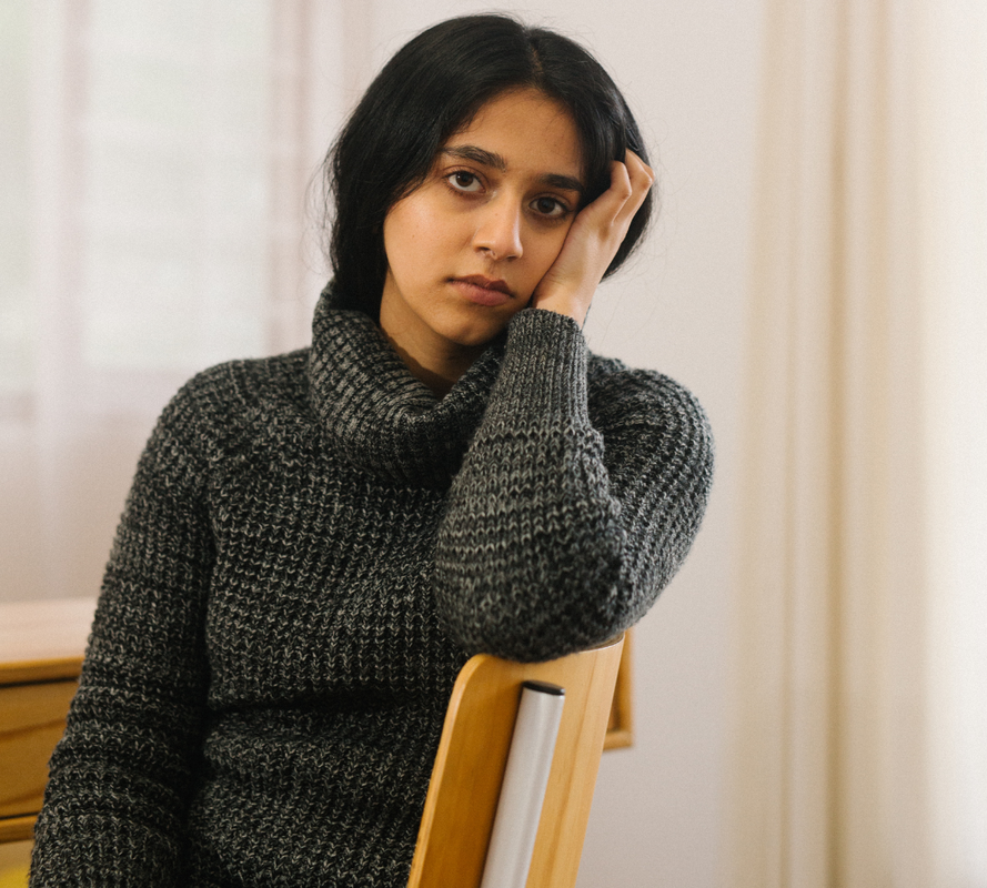 Woman sitting at table, stressed