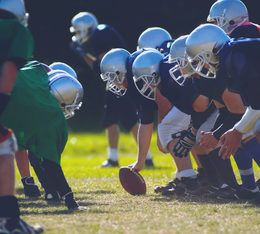 A lineup of football players on the field during a game.