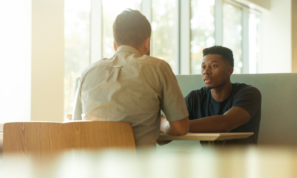 man having a conversation with a weight loss coach